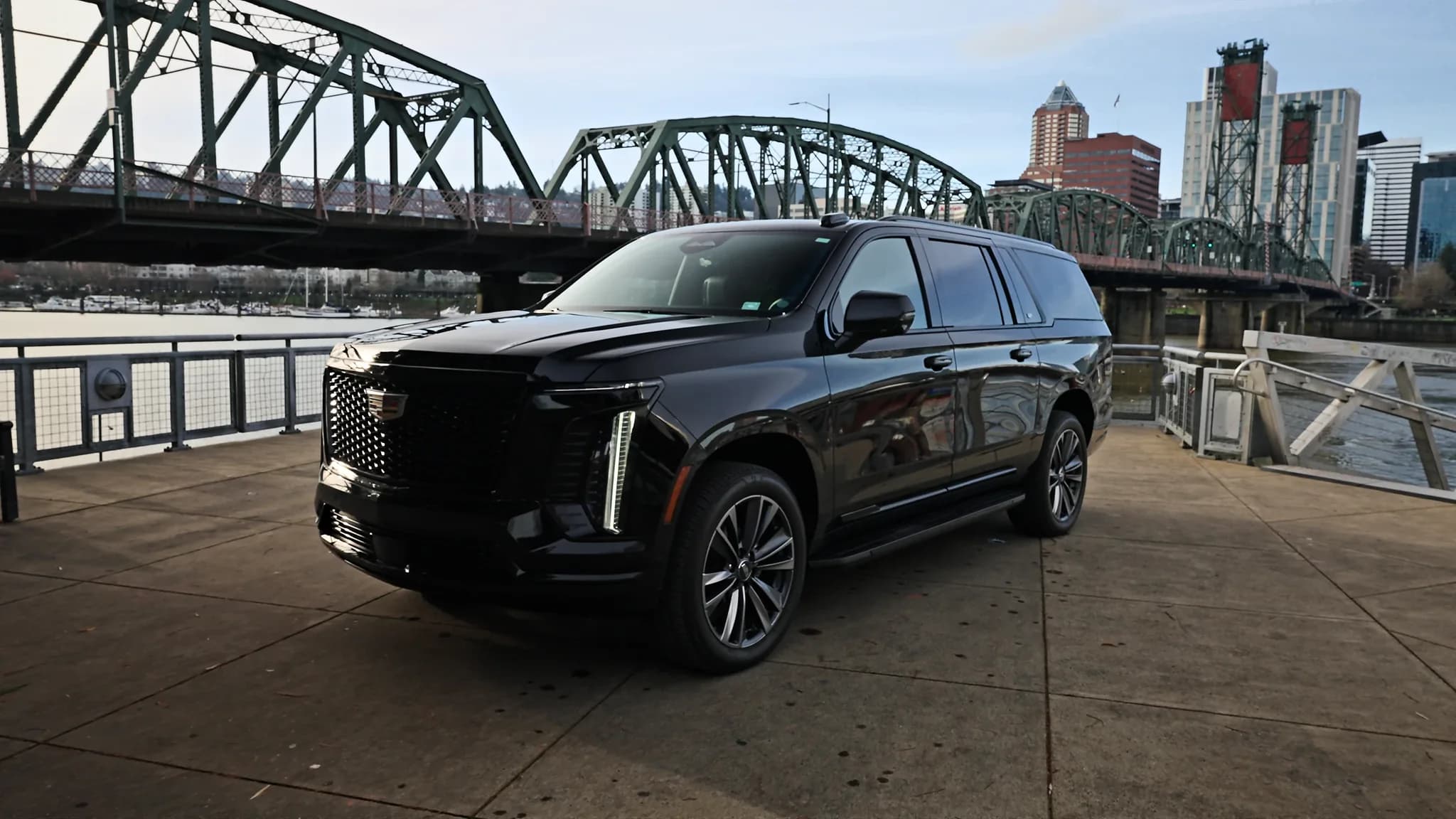 Cadillac Escalade ESV parked on the Portland waterfront with the Hawthorne Bridge behind