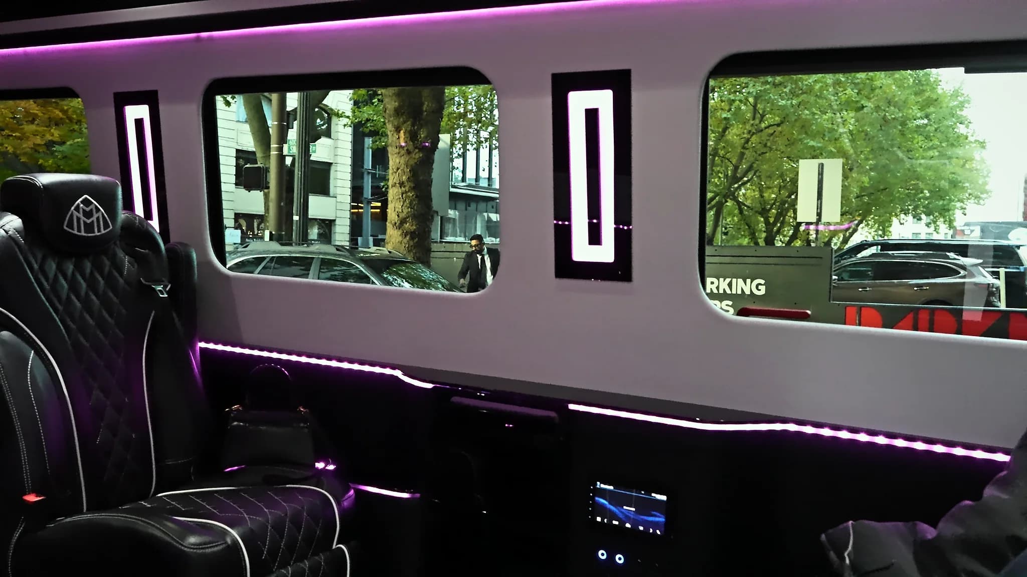 Sprinter Jet Limousine lounge cabin with facing leather seats and lit window panels