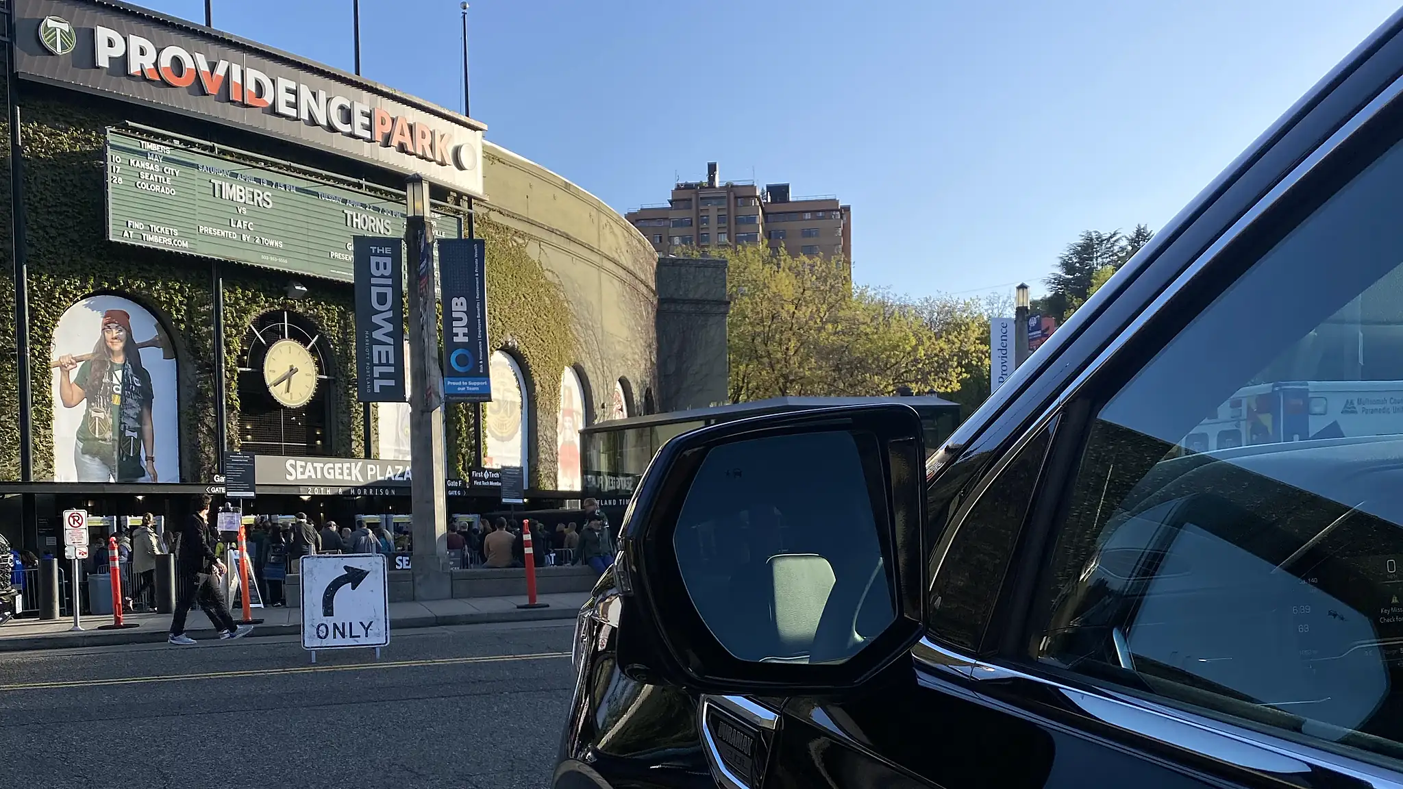 Black Cadillac Escalade parked across from Providence Park — Portland limo service at a downtown venue