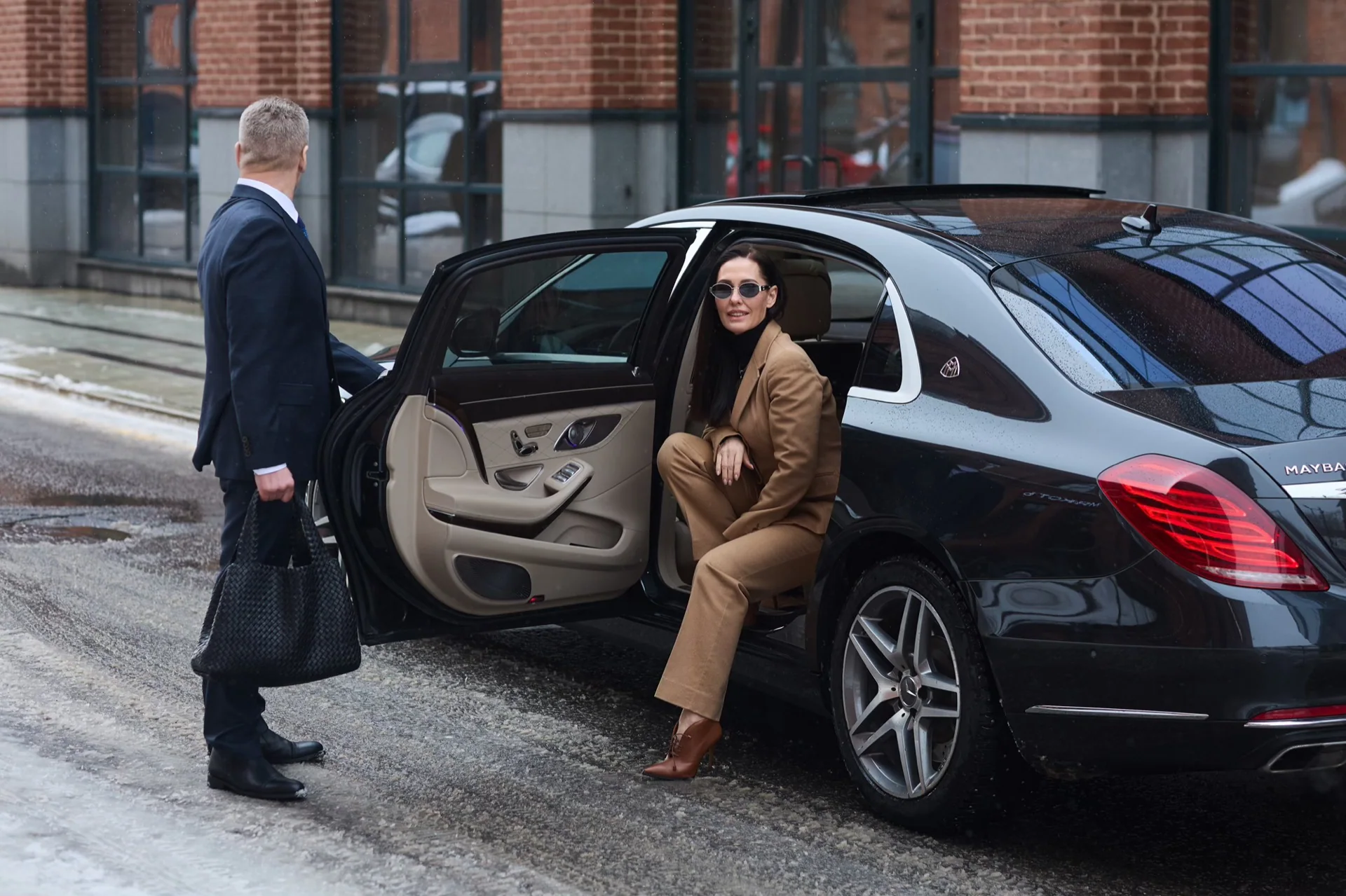 Portland chauffeur opening a luxury sedan rear door for a Marquee Chauffeur PDX transfer